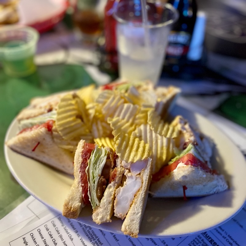 A plate of sandwiches and potato chips