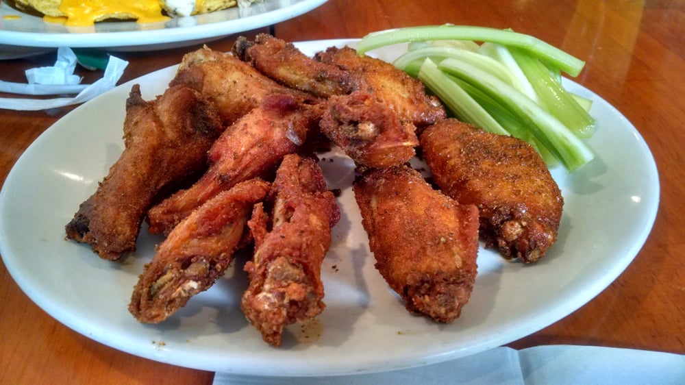 A plate of wings with celery