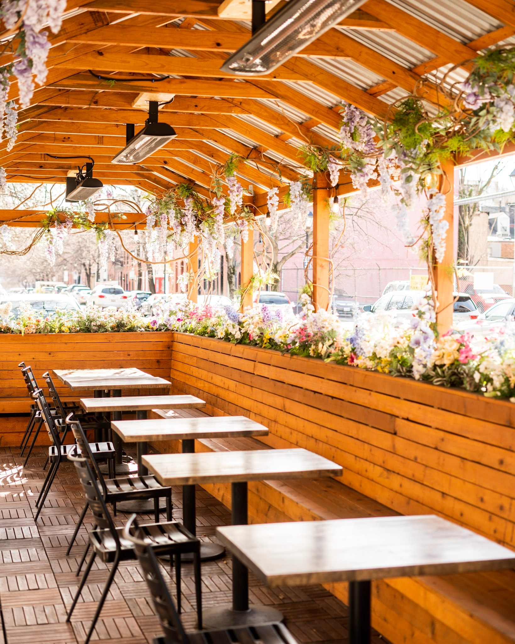 Outdoor seating under a pavilion covered in flowers