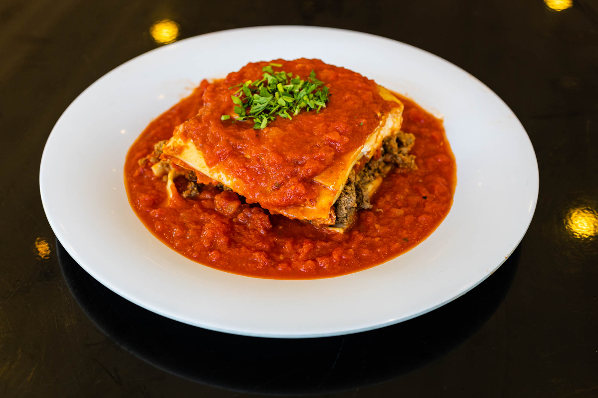 A plate with a piece of lasagna