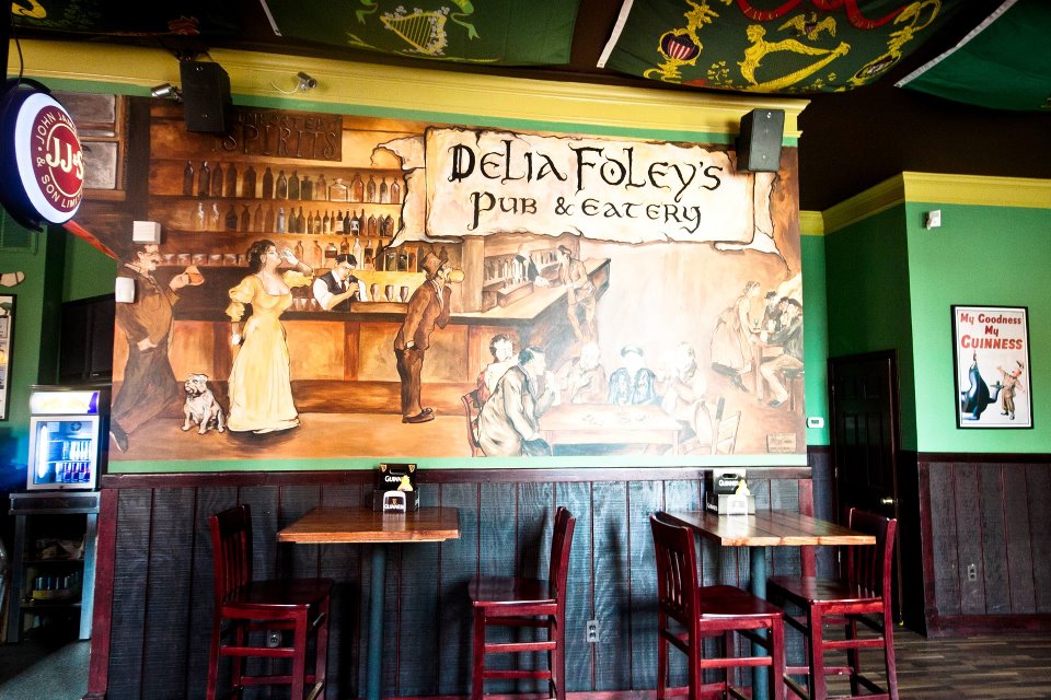 A mural of an old-timey bar inside Delia Foley's, that reads: Delia Foley's Pub & Eatery