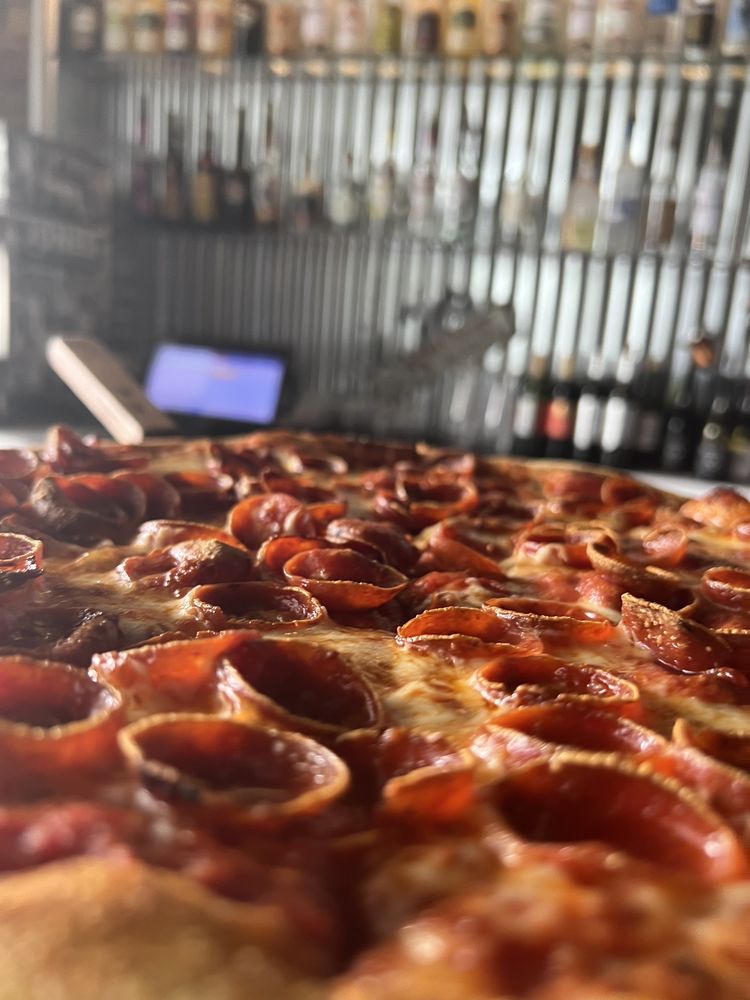 A close up photo of a pepperoni pizza