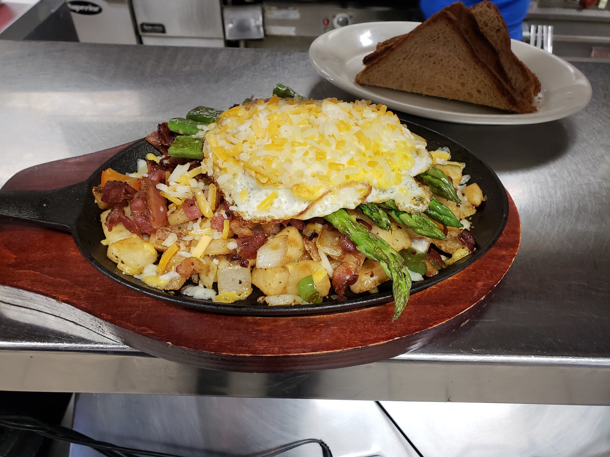 Home fries with asparagus, bacon, and a fried egg