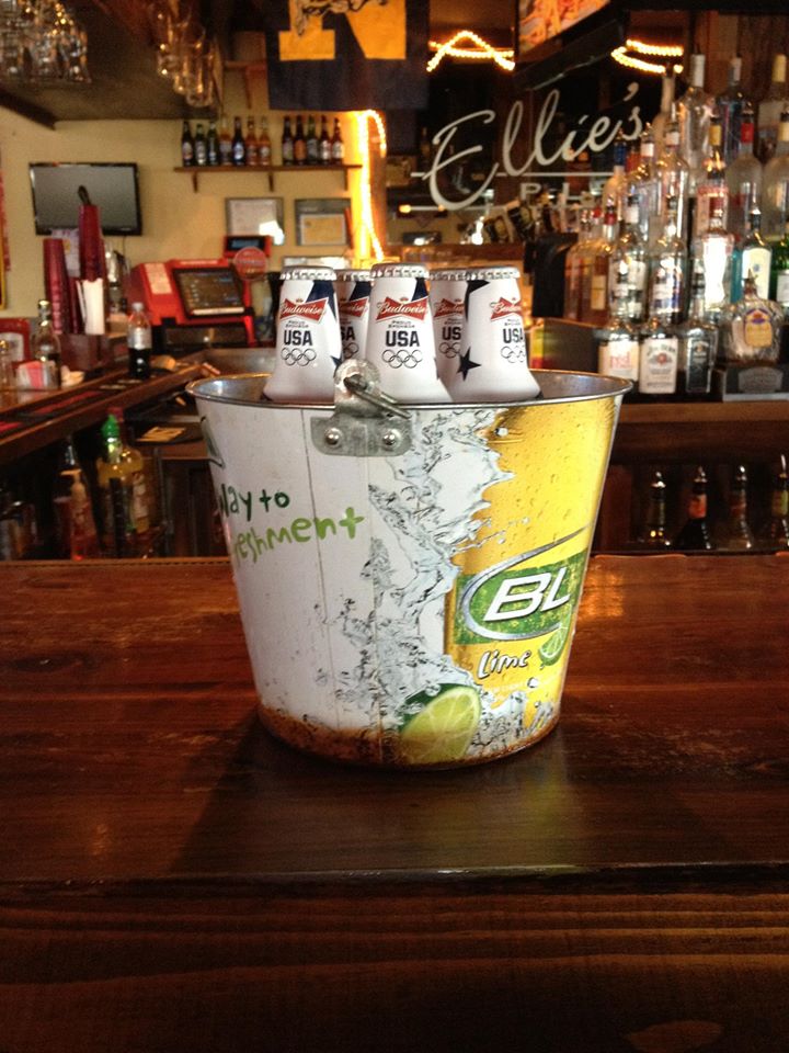 a bucket of beer on a bar counter