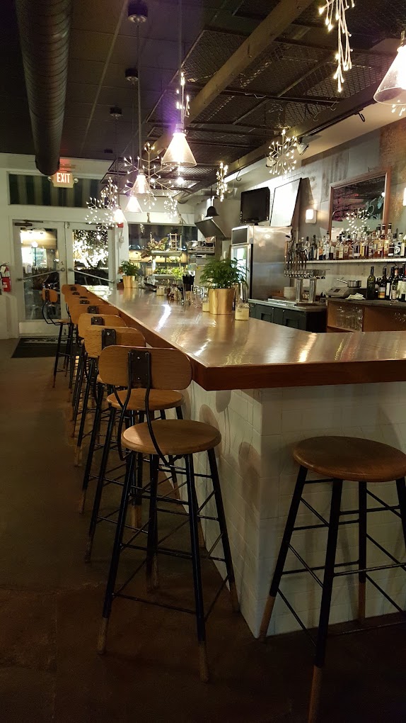interior of grand cru bottle shop, a bar with stools
