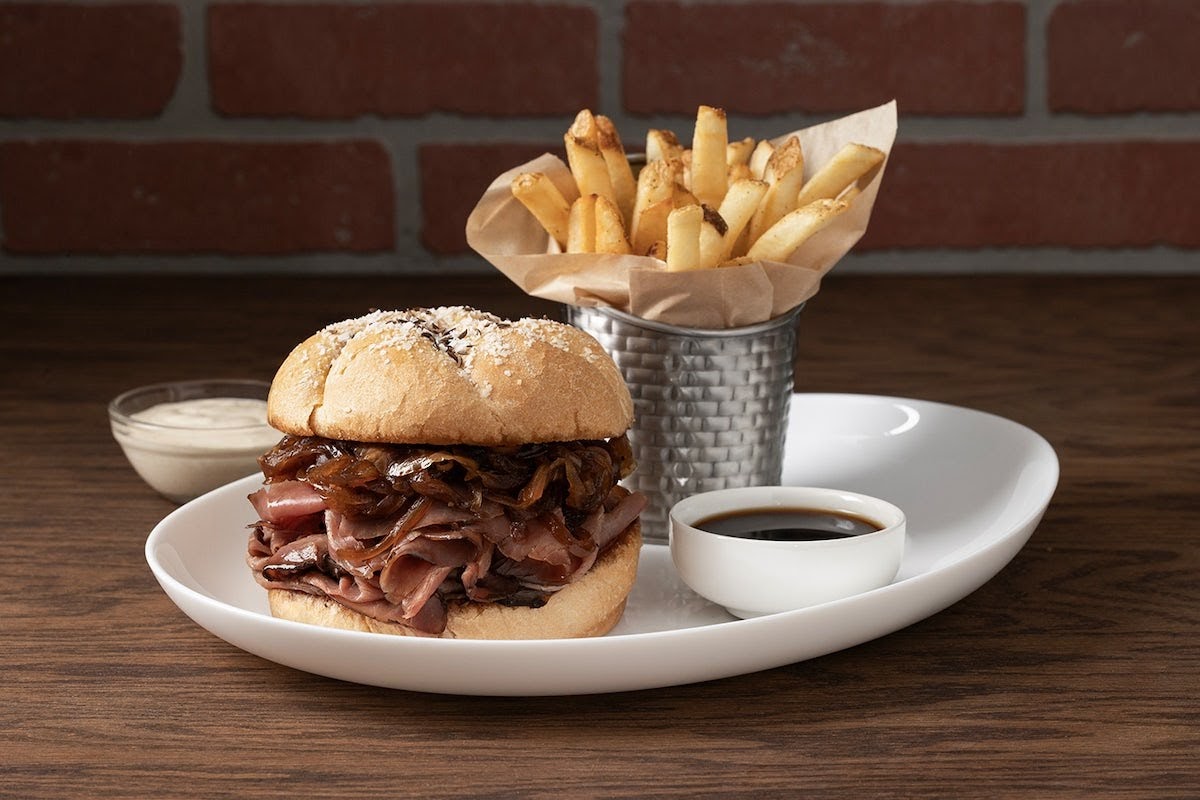 a beef on weck sandwich with fries and sauces