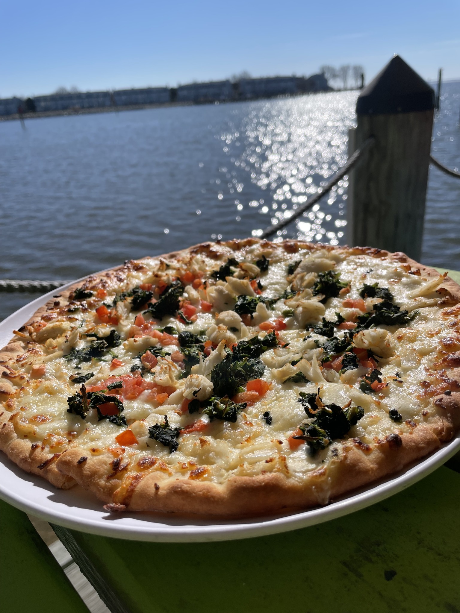 a pizza on a table along the dock