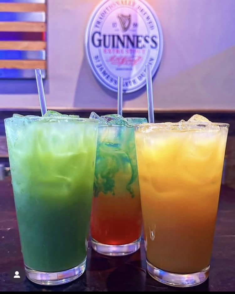 three colorful mixed drinks on a table
