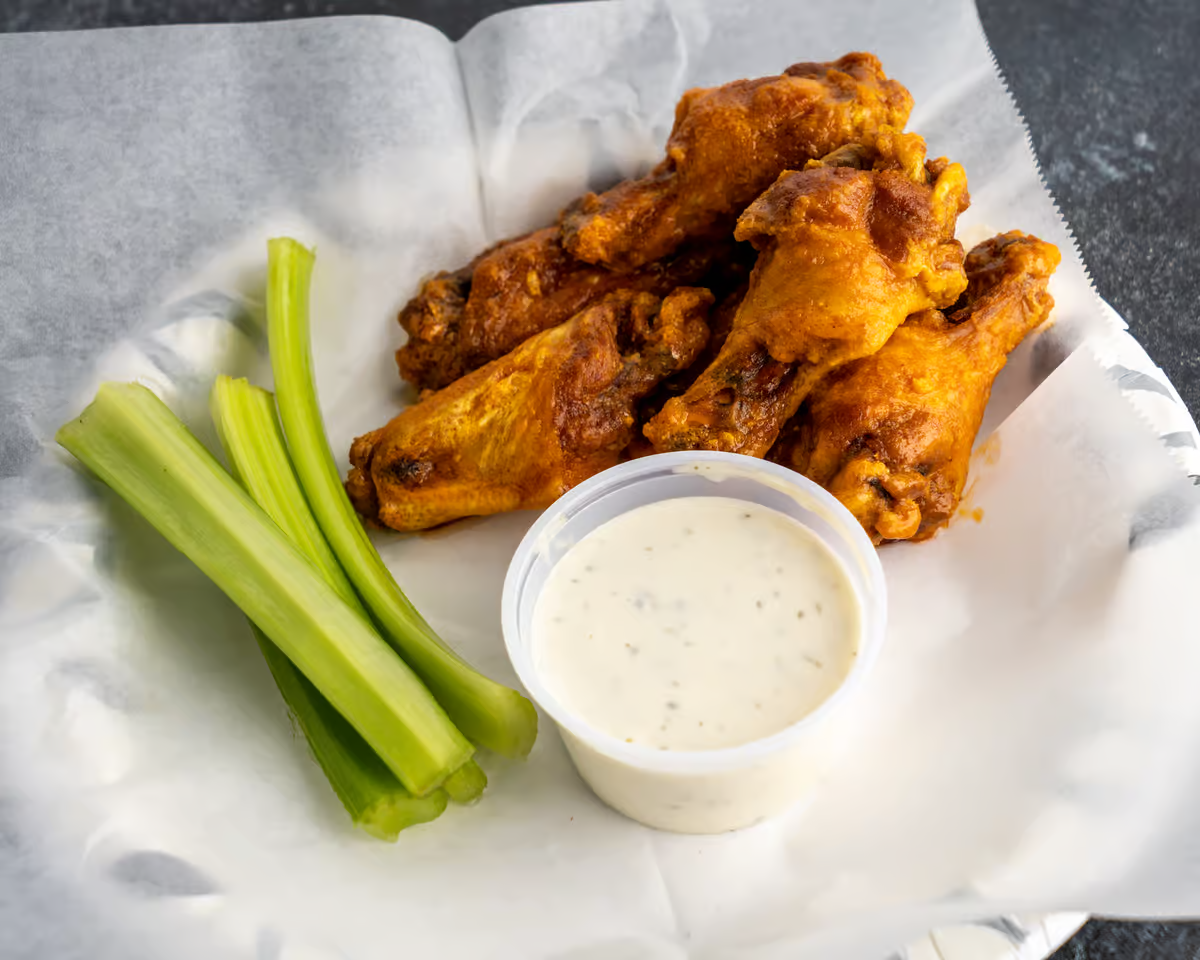 wings with dipping sauce and celery