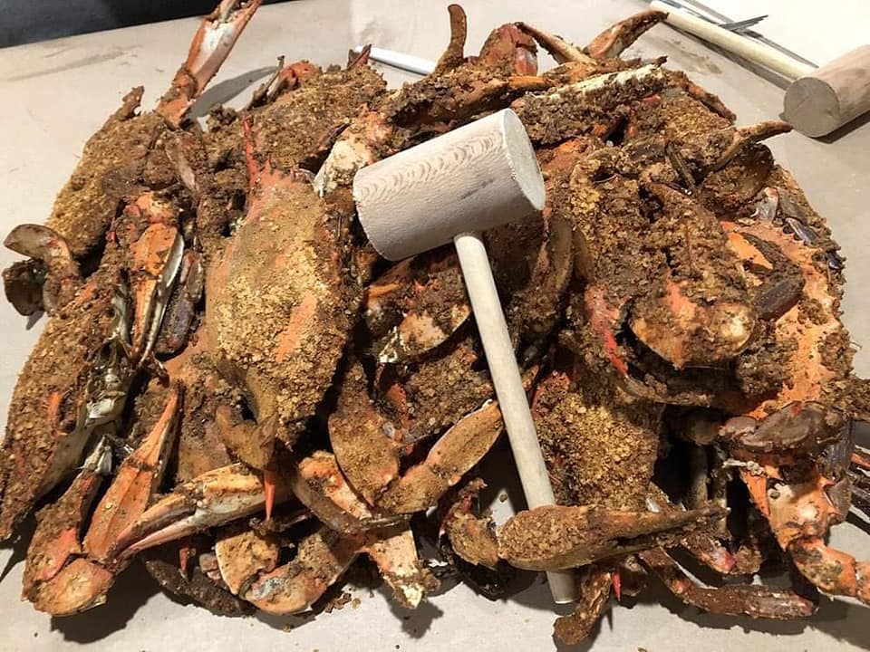 Pile of steamed crab with wooden mallet