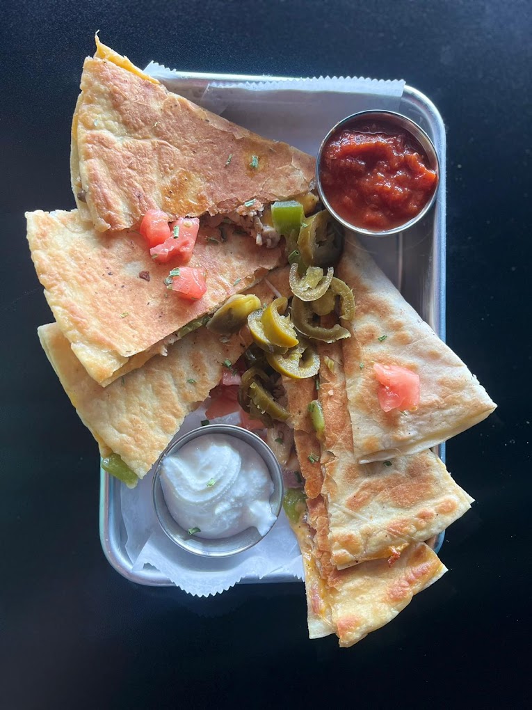 a quesadilla and salsa on a plate