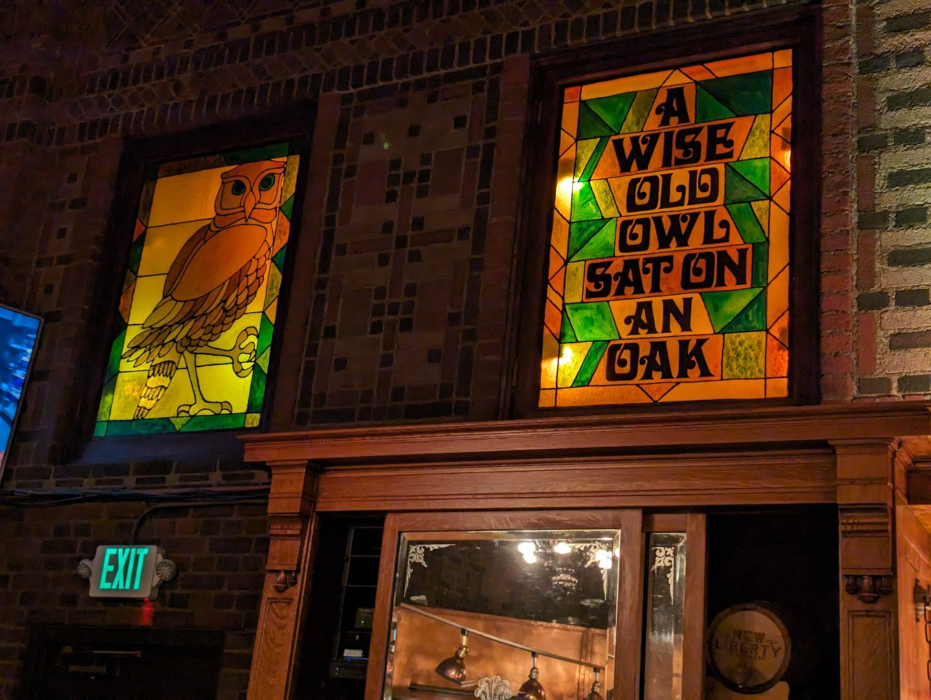Owl stained glass windows above bar