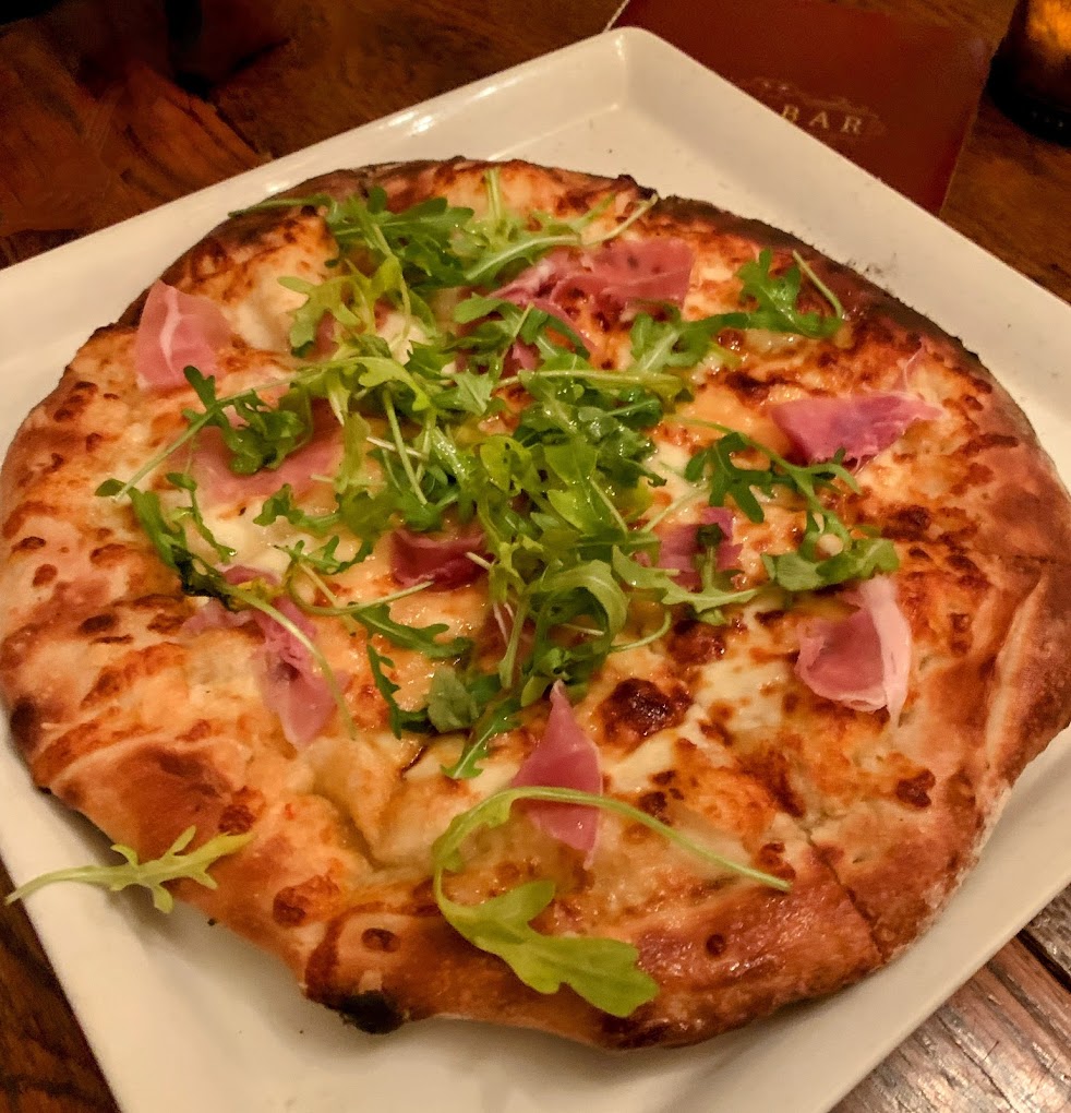 pineapple and prosciutto pizza on a plate 