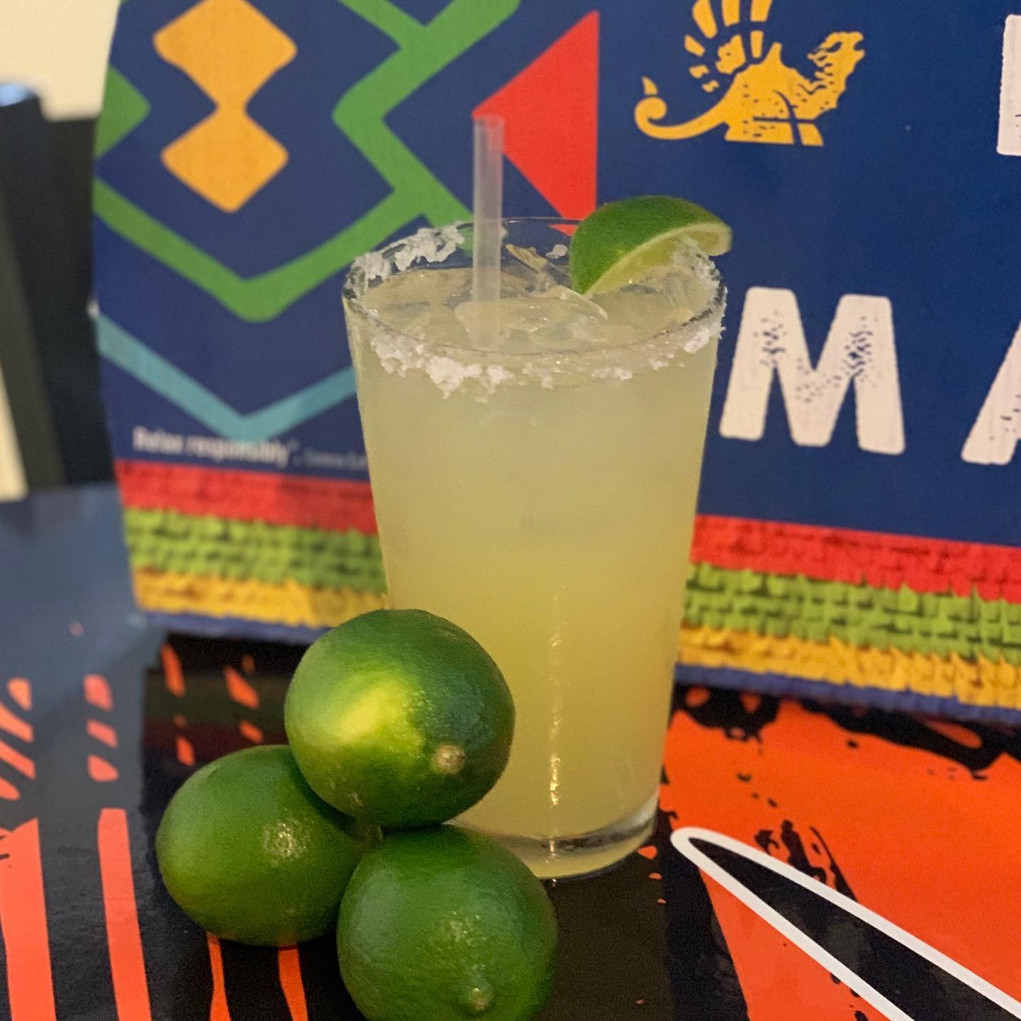 a margarita with three limes on the side
