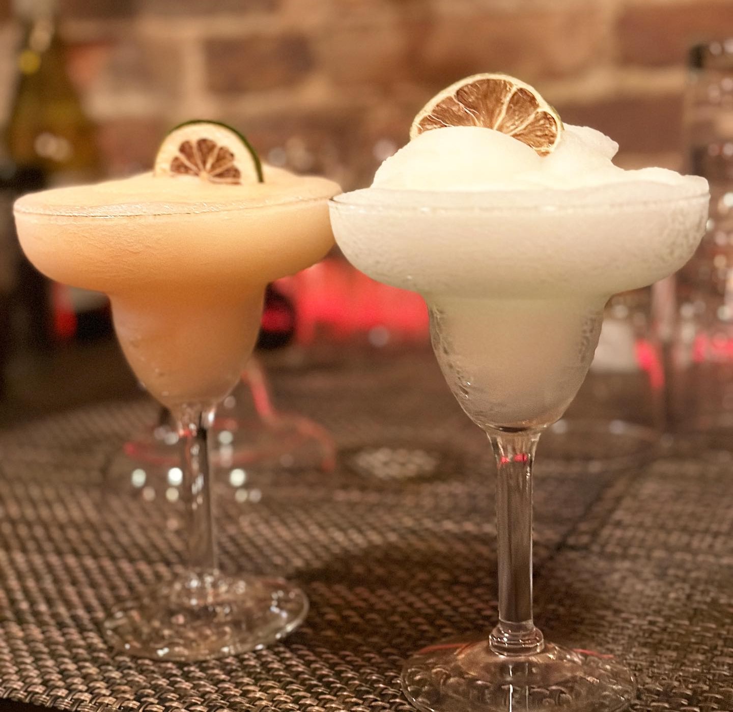 two frozen margaritas on a table