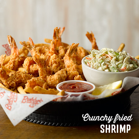a basket of crunchy fried shrimp with dips