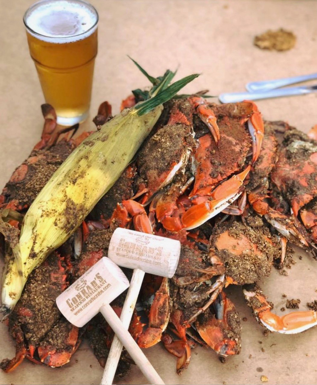 a pile of crabs with corn and beer