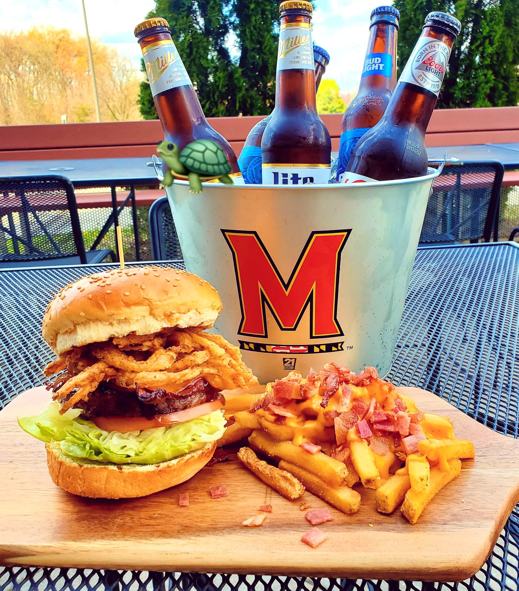 a burger with fries and a bucket of beer