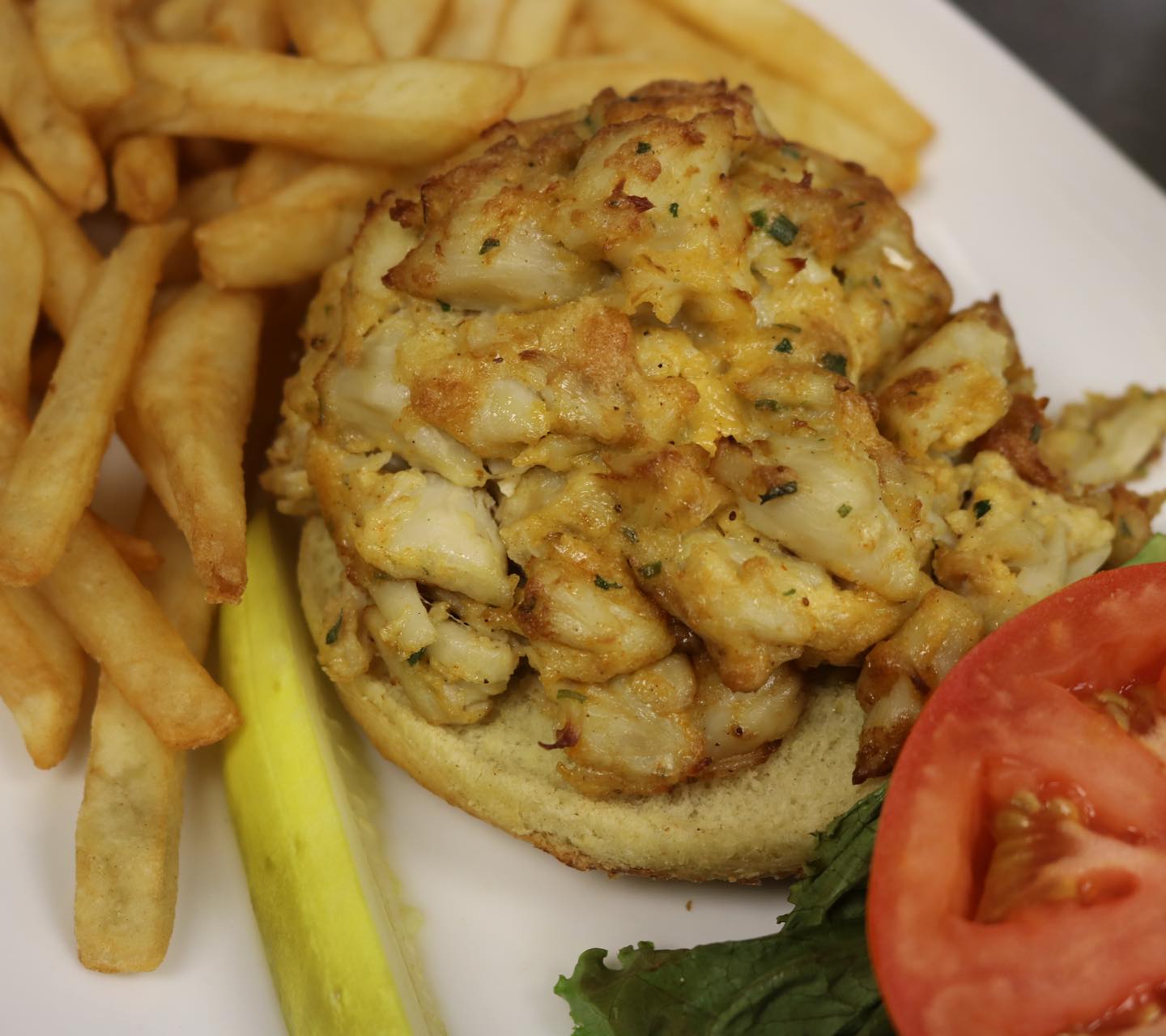 a crab cake sandwich with fries