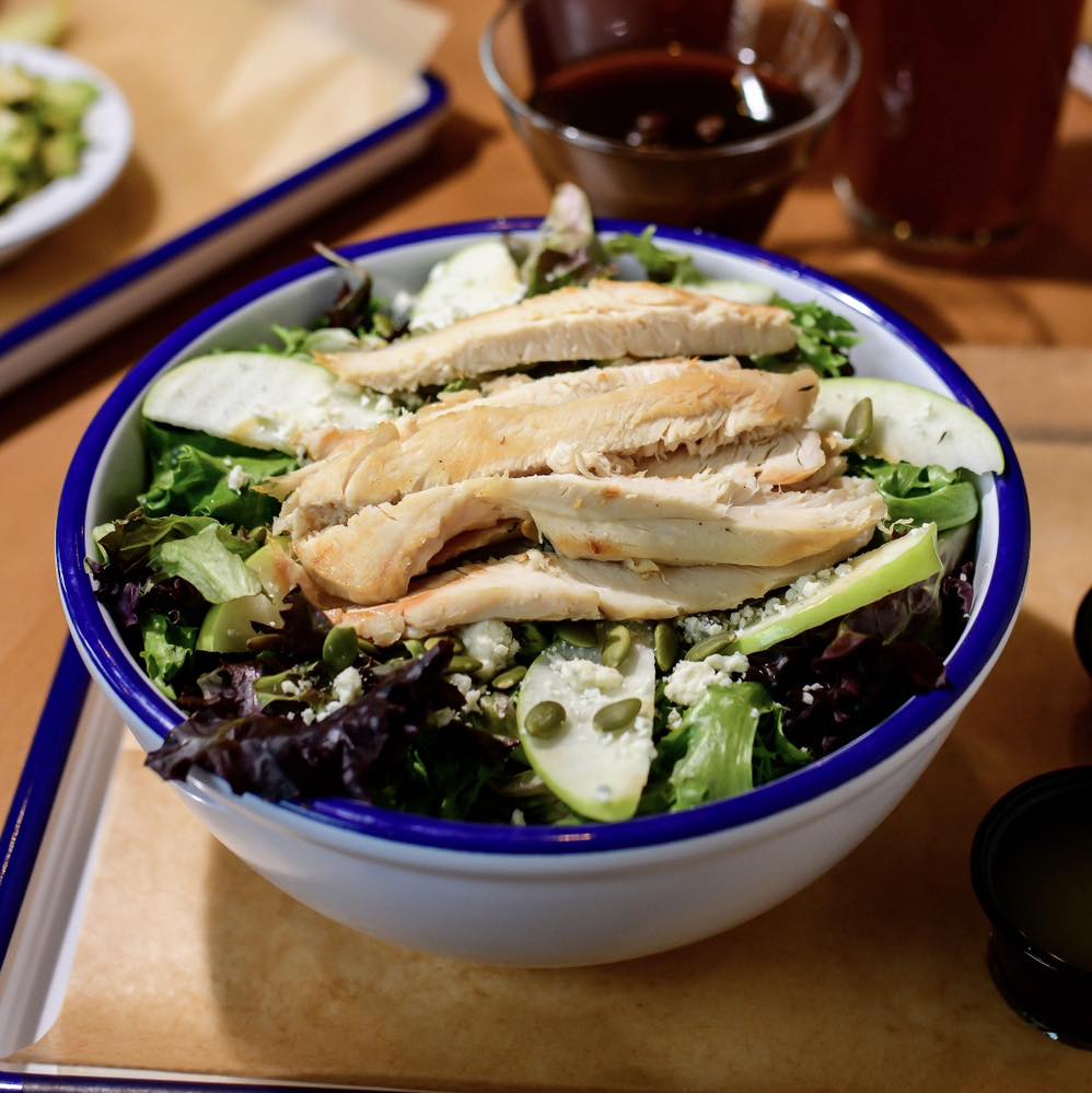 a salad with chicken in a bowl