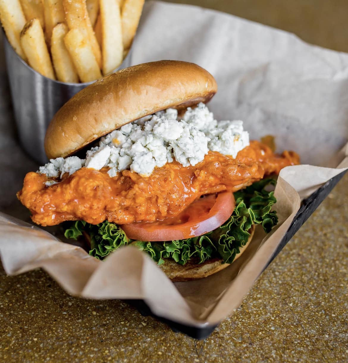 a buffalo chicken sandwich with fries