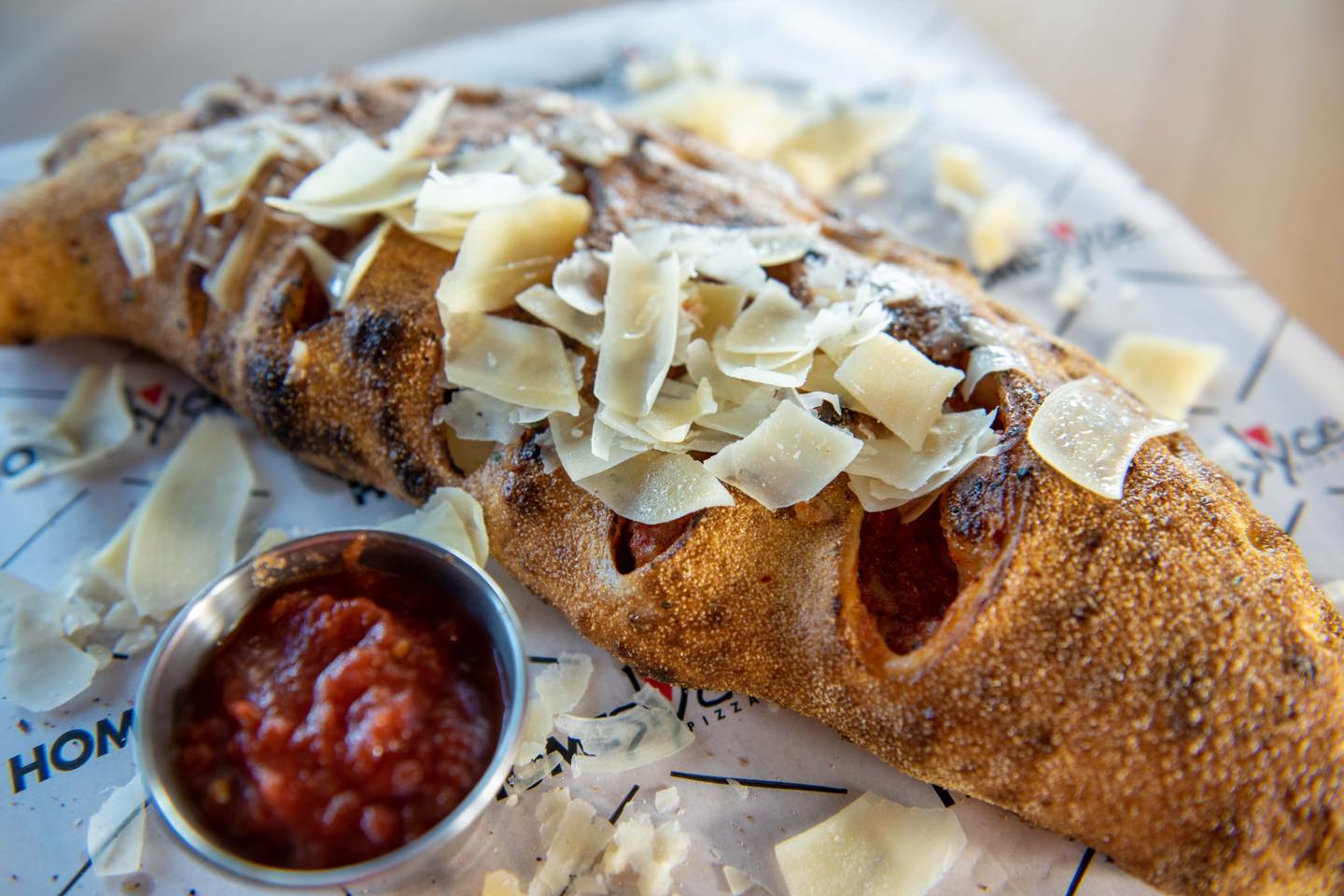 a calzone with dip and parmesan