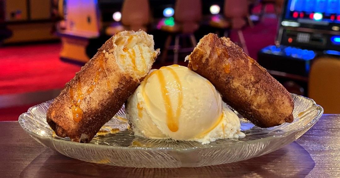 a plate of Cheesecake Chimichangas with vanilla ice cream