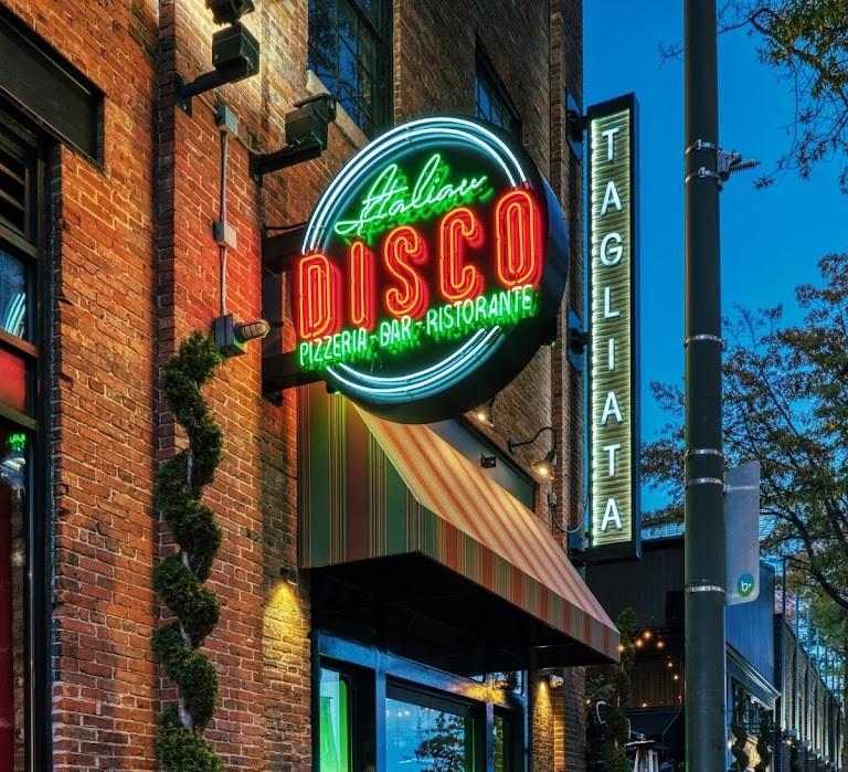 exterior of italian disco, with a neon sign of their logo
