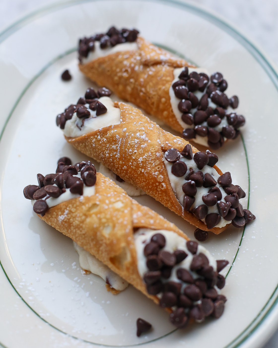 a plate of cannoli with chocolate chips