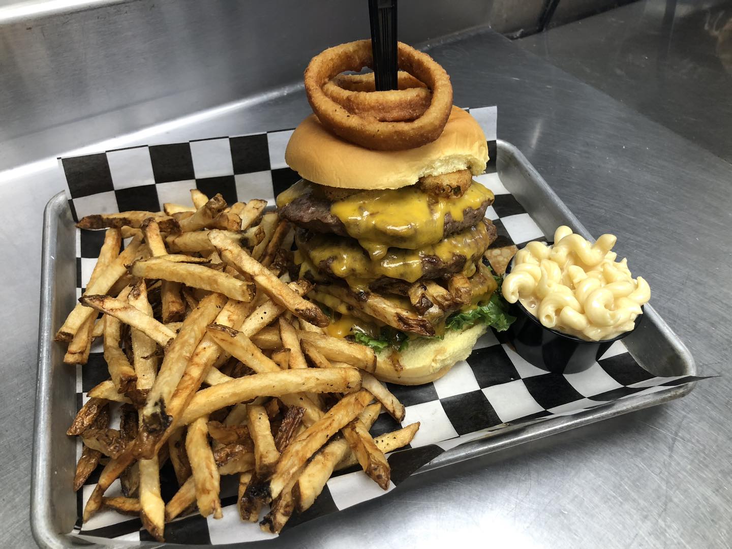 a burger with fries and mac & cheese