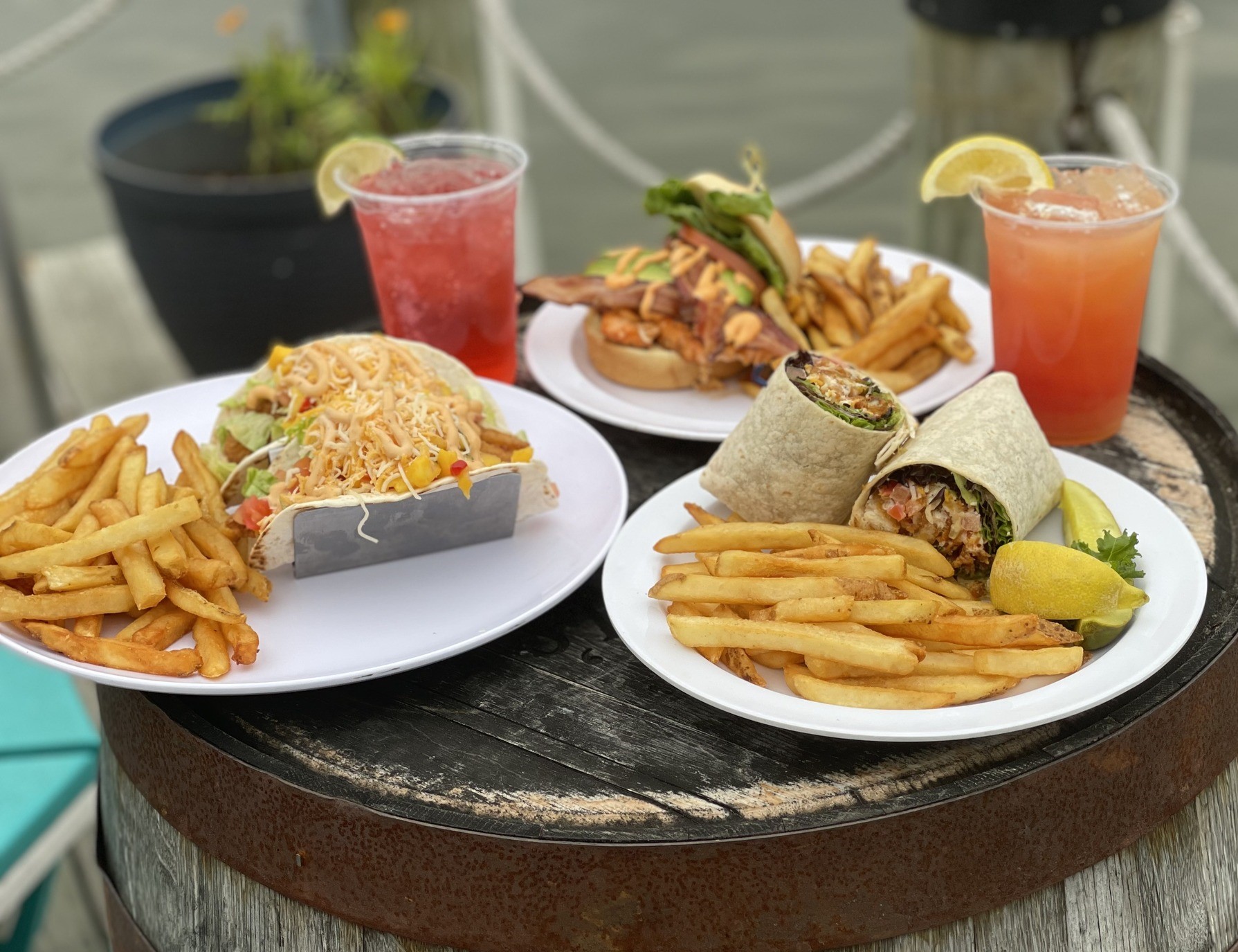 plates of food with drinks on a barrel
