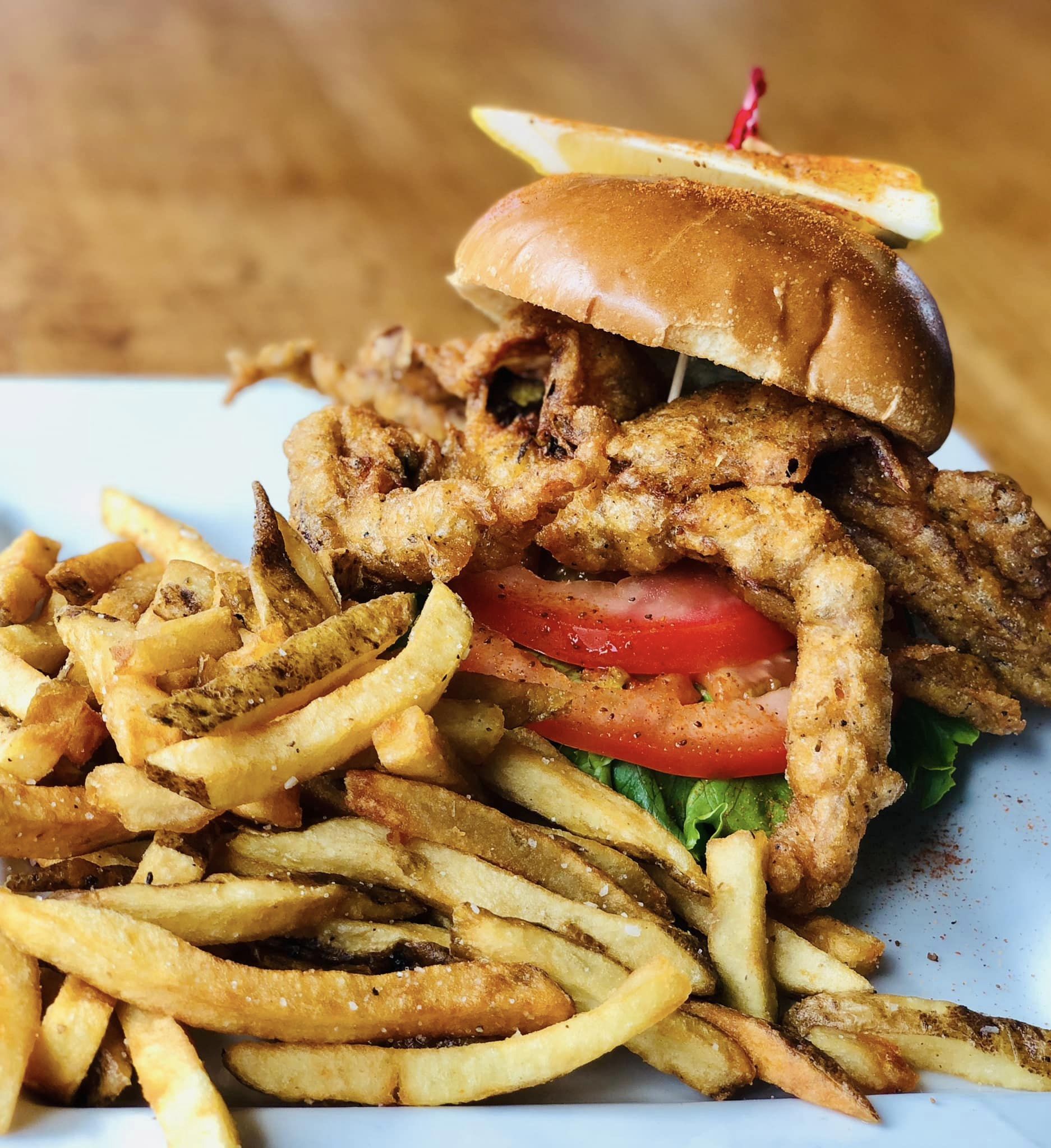 a soft shell crab sandwich with fries