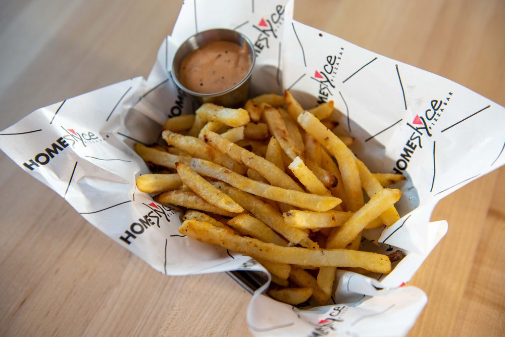 a basket of fries with dip