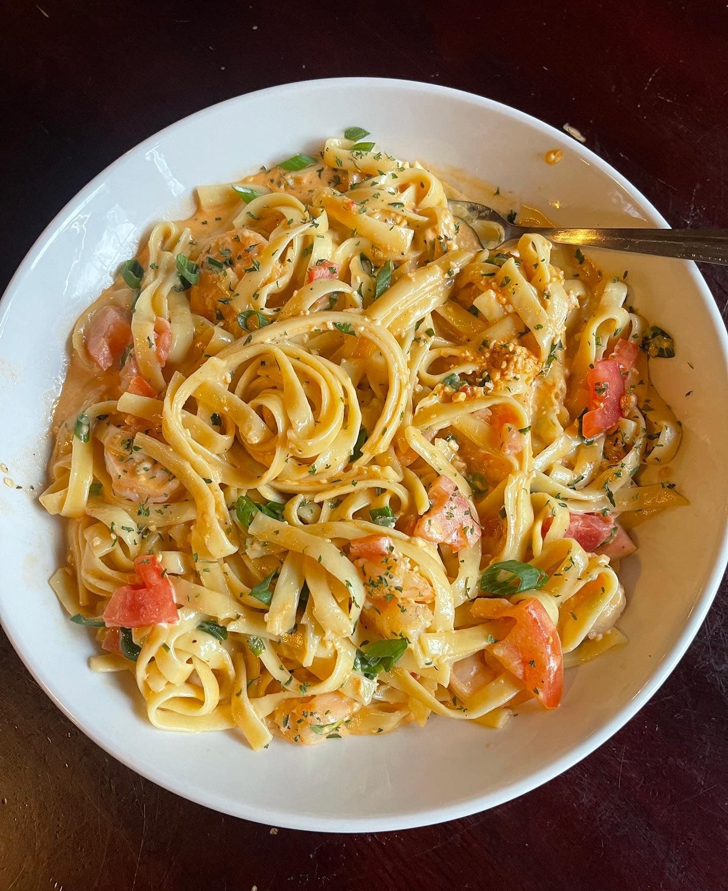 a bowl of Tuscan Shrimp Alfredo pasta