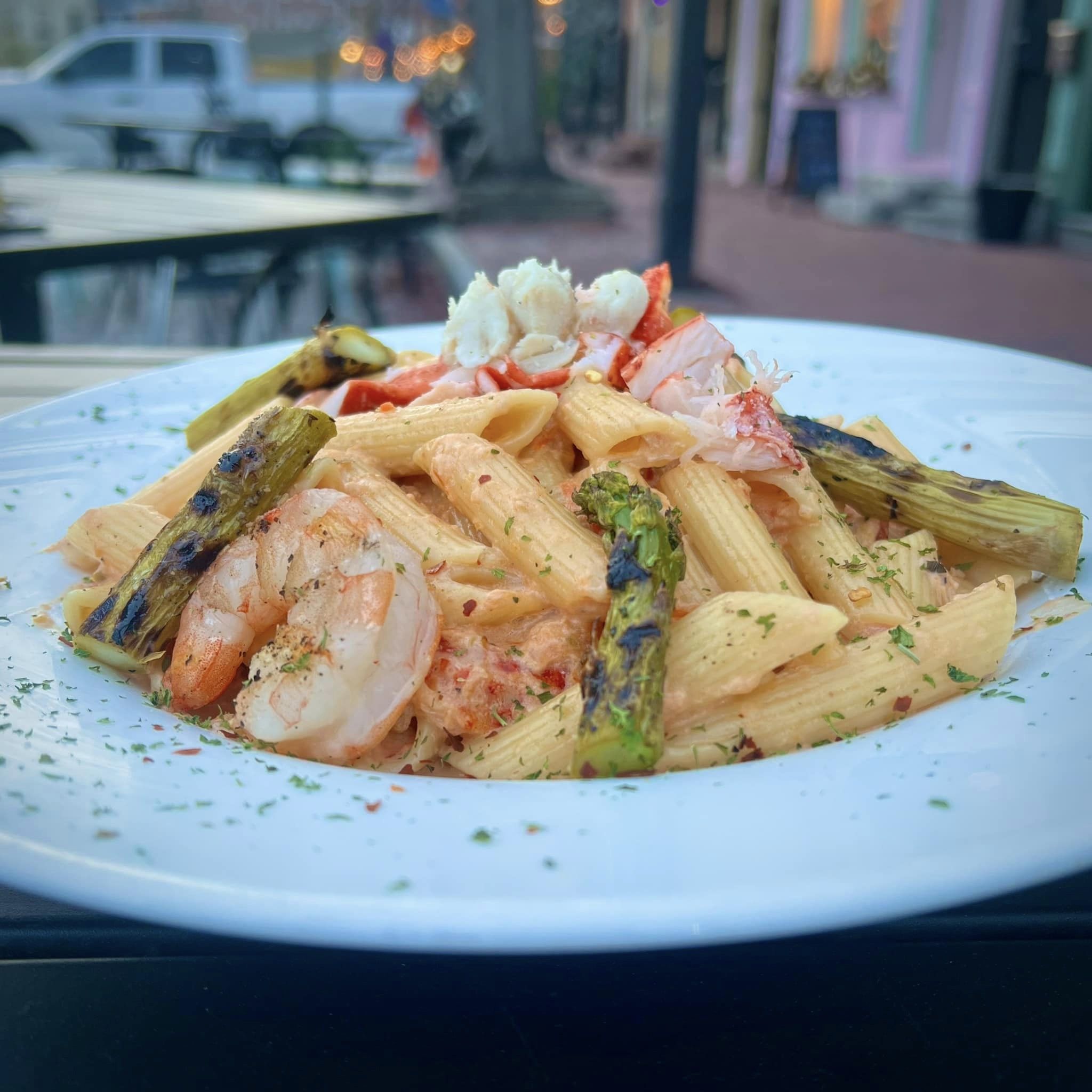 a bowl of pasta with shrimp and asparagus