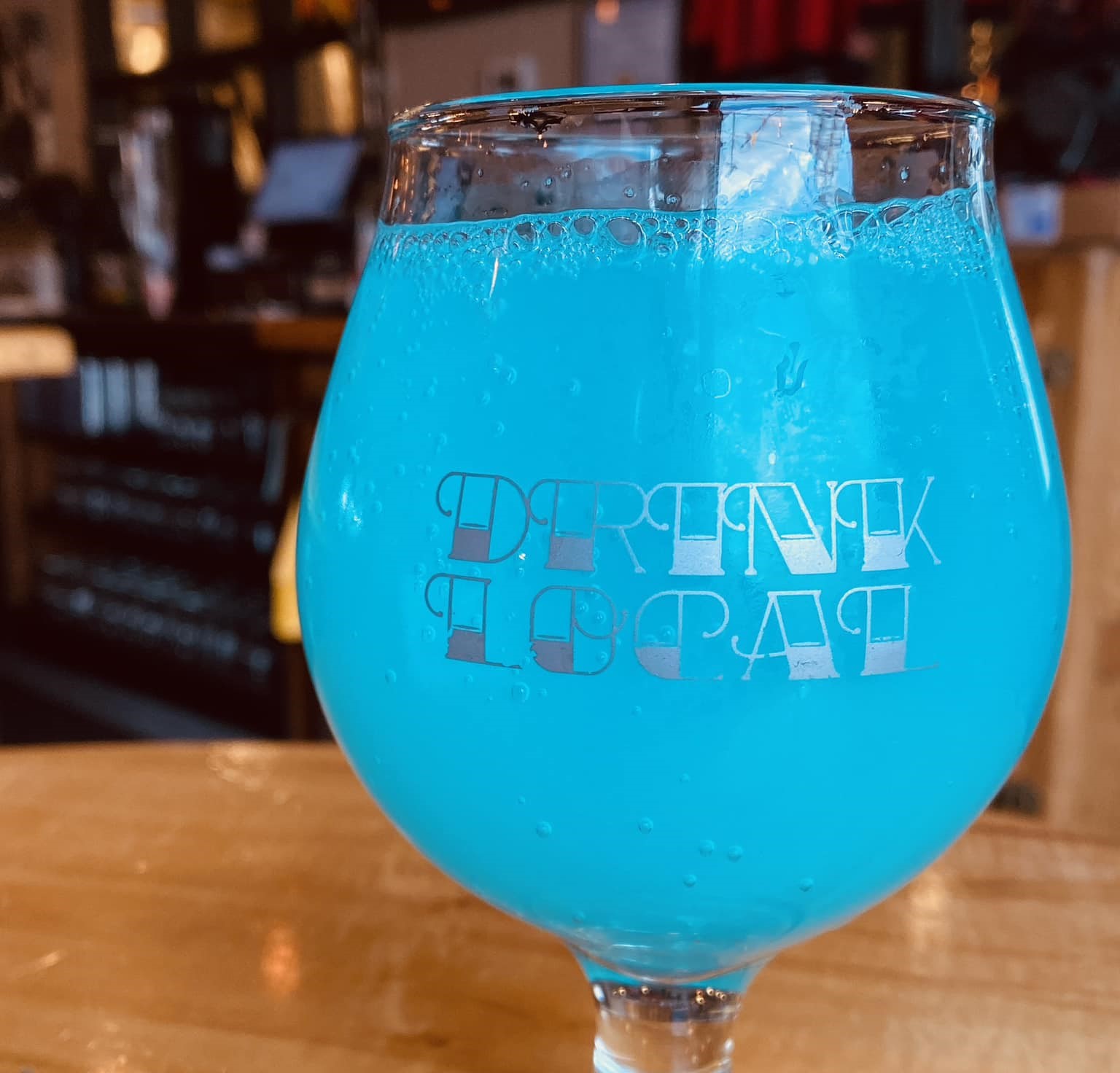 a glass of electric blue beer
